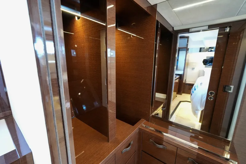 Slide: The Image of Luxurious interior of 2023 Prestige 590 yacht featuring elegant wood cabinetry and modern design. - 95