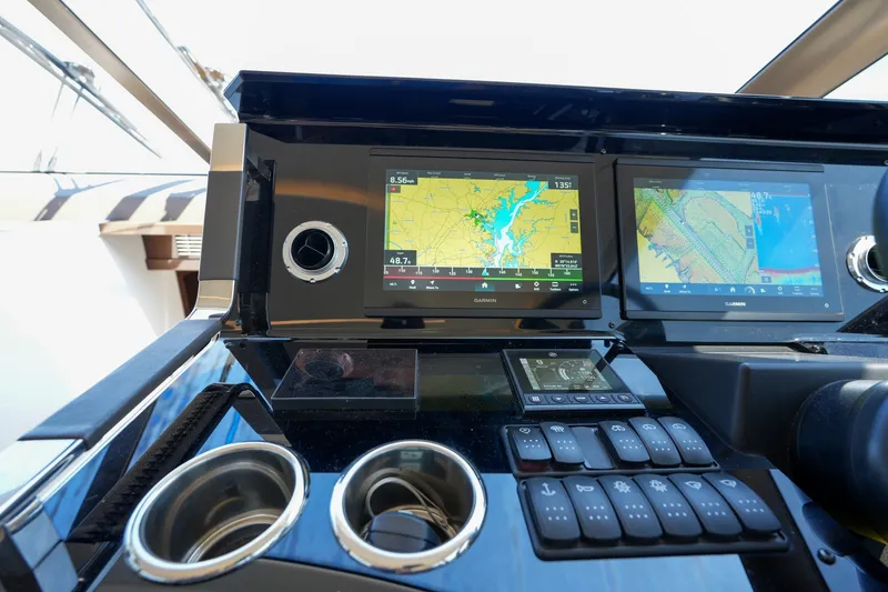 Slide: The Image of Control panel of 2023 Prestige 590 yacht with navigation screens and controls. - 71
