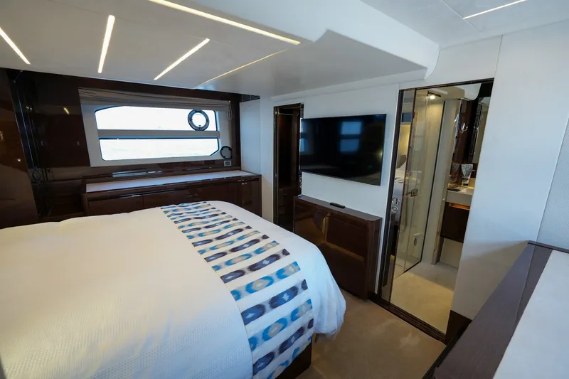Slide: The Image of Luxurious 2023 Prestige 590 yacht bedroom with modern decor and large window view. - 90