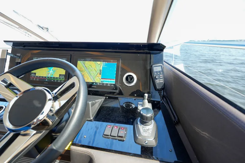 Slide: The Image of Cockpit of 2023 Prestige 590 yacht with navigation screens and steering wheel. - 72
