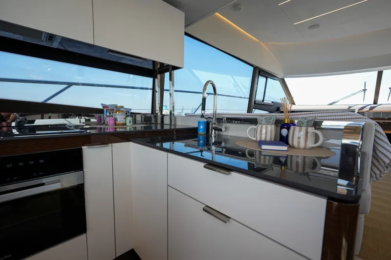 Slide: The Image of Modern kitchen interior on 2023 Prestige 590 yacht with sleek design and ocean view. - 55