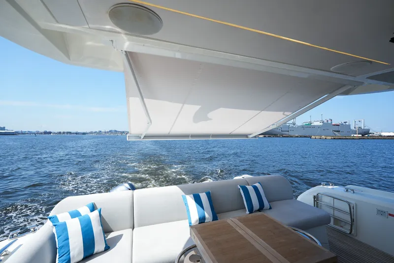 Slide: The Image of Luxury yacht Prestige 590, 2023 model, with elegant seating and ocean view. - 23