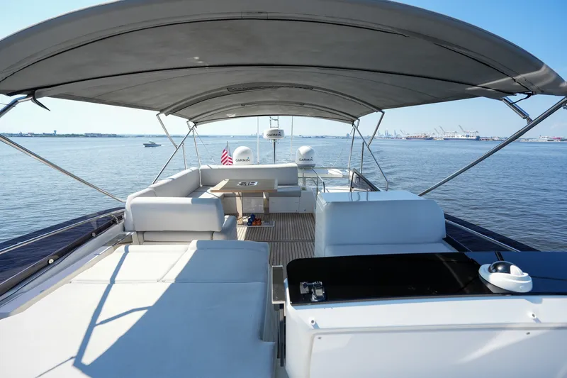 Slide: The Image of Luxurious 2023 Prestige 590 yacht deck with seating, ocean view, and canopy. - 3