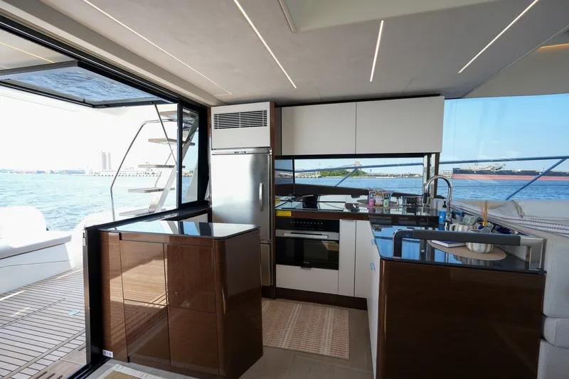 Slide: The Image of Luxurious 2023 Prestige 590 yacht kitchen with modern appliances and ocean view. - 53
