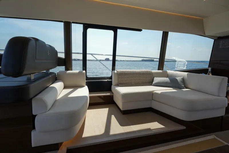 Slide: The Image of Luxurious interior of 2023 Prestige 590 yacht with elegant seating and panoramic ocean view. - 64
