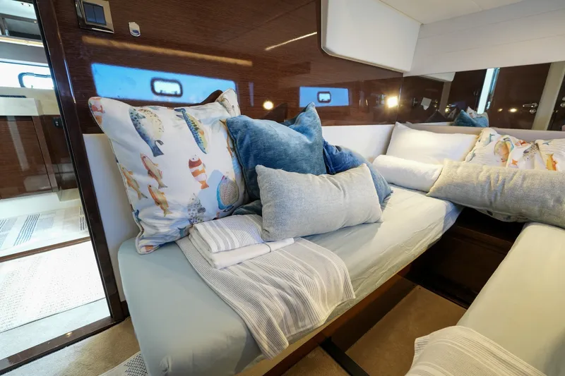 Slide: The Image of Luxurious 2023 Prestige 590 yacht cabin with plush pillows and elegant bedding. - 84