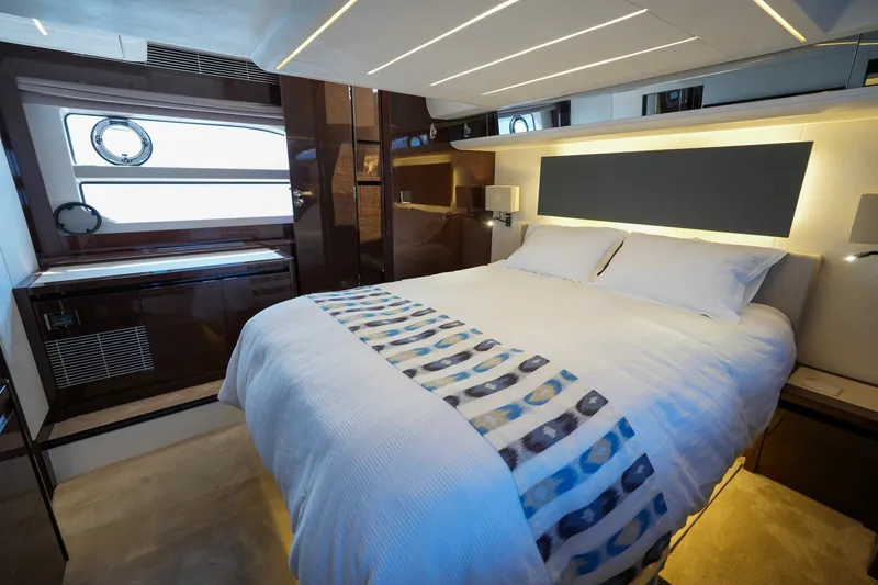 Slide: The Image of Luxurious bedroom interior on 2023 Prestige 590 yacht, featuring modern design and elegant lighting. - 92