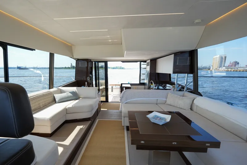 Slide: The Image of Luxurious interior of 2023 Prestige 590 yacht with panoramic water views and elegant seating. - 52