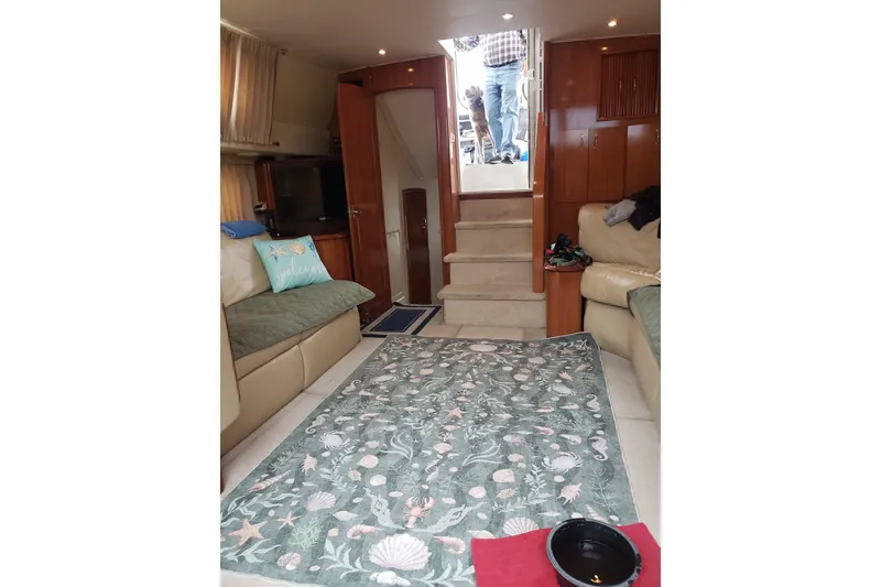 Slide: The Image of Interior of 2005 Carver 444 Cockpit Motor Yacht with cozy seating and decorative rug. - 7