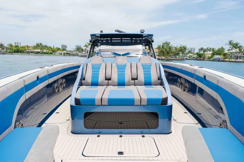 Slide: The Image of 2026 Midnight Express 52 Vitesse luxury boat with blue and gray seating on a sunny day. - 15