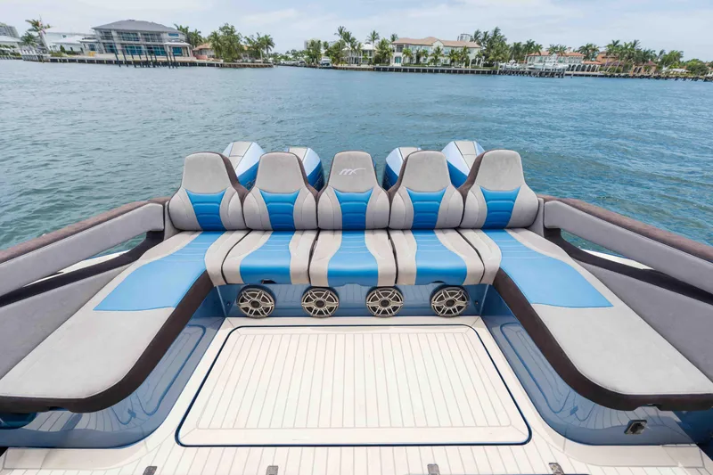 Slide: The Image of Luxury seating on 2026 Midnight Express 52 Vitesse boat, featuring blue and gray upholstery. - 20