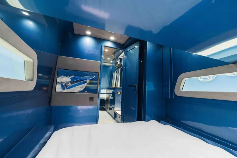 Slide: The Image of Luxurious interior of 2026 Midnight Express 52 Vitesse yacht with blue accents and modern design. - 49