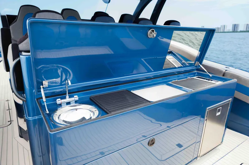 Slide: The Image of Luxury outdoor kitchen on 2026 Midnight Express 52 Vitesse yacht, featuring sink and grill. - 25