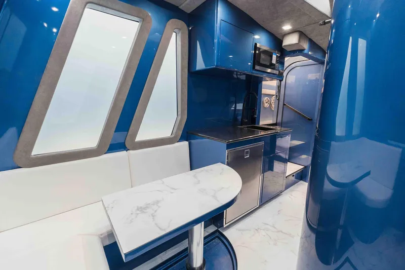 Slide: The Image of Luxurious interior of 2026 Midnight Express 52 Vitesse yacht with sleek blue design and modern amenities. - 43