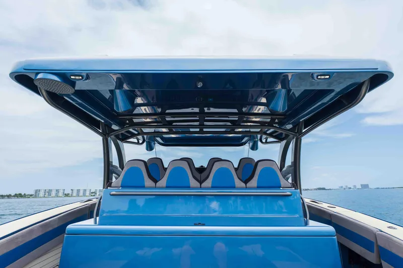 Slide: The Image of 2026 Midnight Express 52 Vitesse luxury boat with sleek blue design on open water. - 23