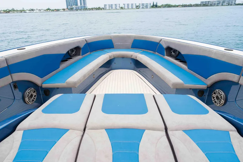 Slide: The Image of Luxurious seating on 2026 Midnight Express 52 Vitesse boat, featuring blue and gray upholstery. - 16