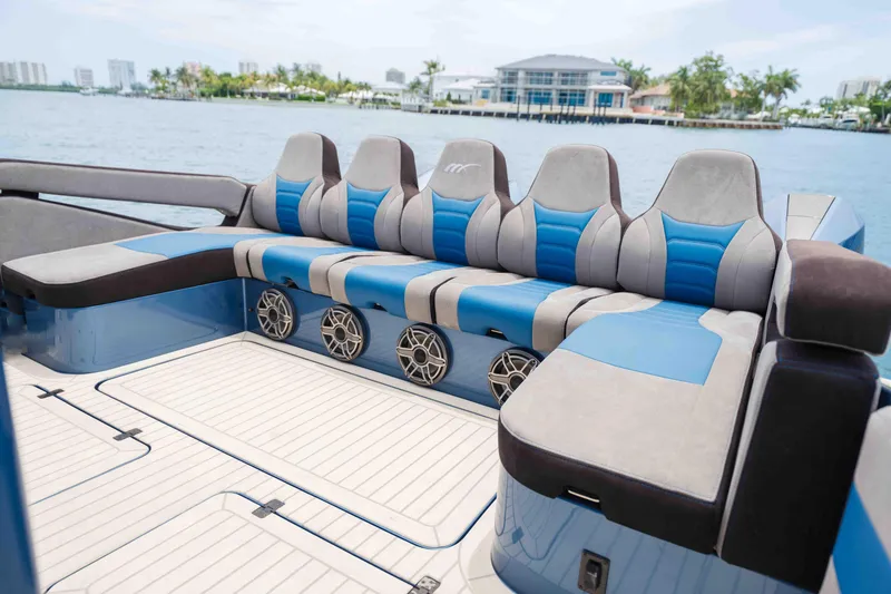 Slide: The Image of Luxurious seating on 2026 Midnight Express 52 Vitesse yacht, featuring blue and gray upholstery. - 19