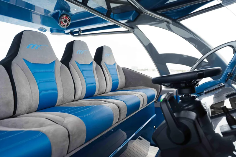 Slide: The Image of Interior of 2026 Midnight Express 52 Vitesse boat with blue and gray seating. - 31