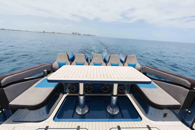 Slide: The Image of Luxury seating area on 2026 Midnight Express 52 Vitesse yacht, cruising on open water. - 36
