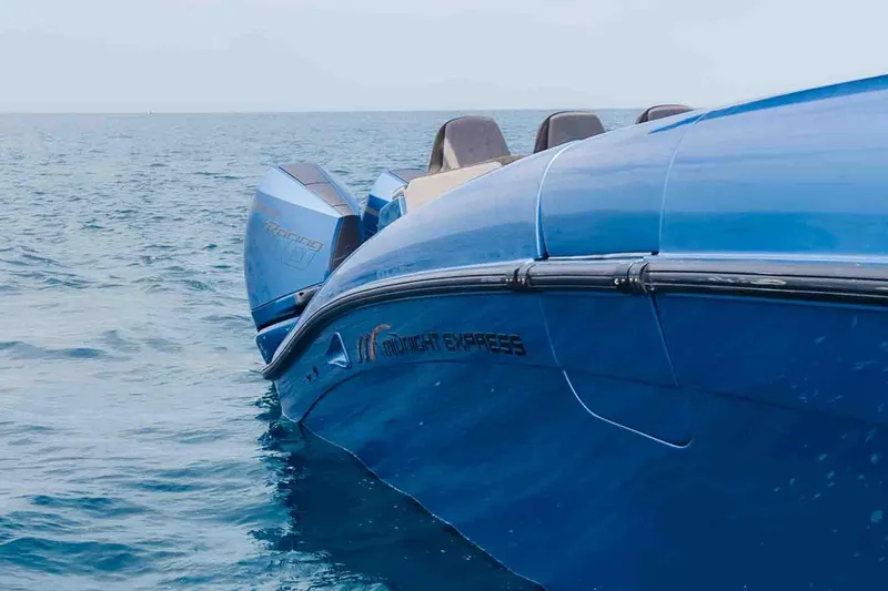 Slide: The Image of Blue 2026 Midnight Express 52 Vitesse boat on open water, showcasing sleek design. - 12