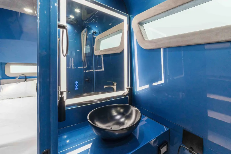 Slide: The Image of Luxurious interior of 2026 Midnight Express 52 Vitesse yacht with modern blue bathroom design. - 48