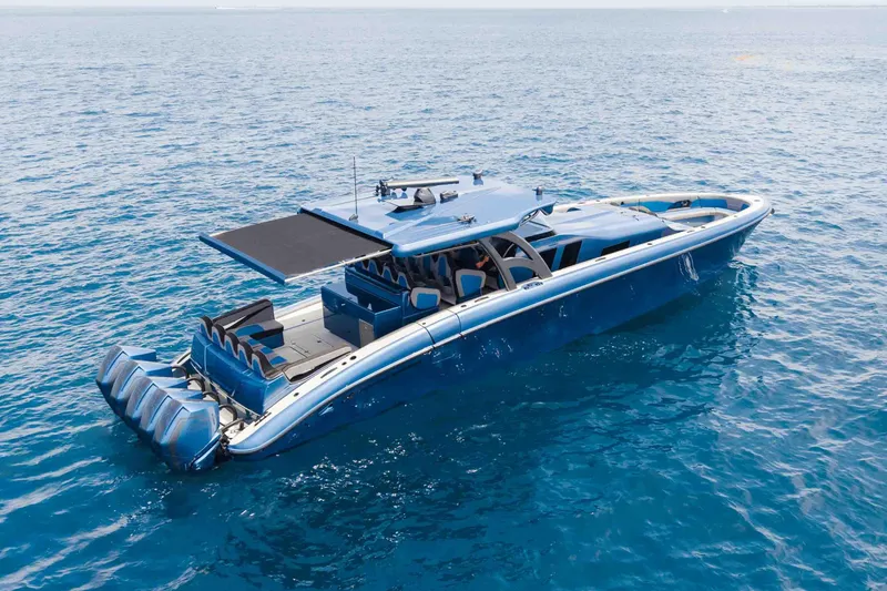 Slide: The Image of Luxurious 2026 Midnight Express 52 Vitesse yacht cruising on clear blue ocean waters. - 7
