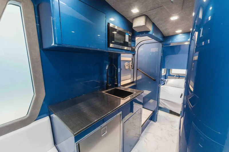 Slide: The Image of Luxurious interior of 2026 Midnight Express 52 Vitesse with sleek blue cabinetry and modern amenities. - 45