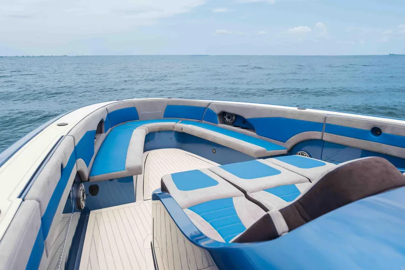 Slide: The Image of Luxurious 2026 Midnight Express 52 Vitesse boat interior with blue seating on open water. - 13