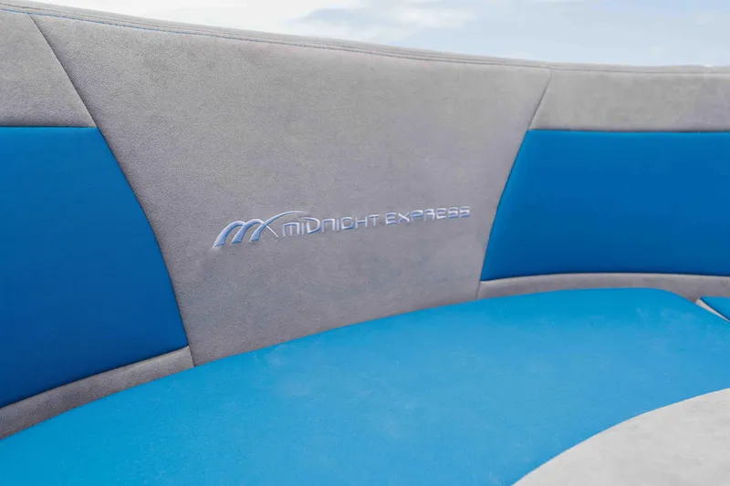 Slide: The Image of Blue and gray seating with "Midnight Express" logo on 2026 Midnight Express 52 Vitesse. - 14