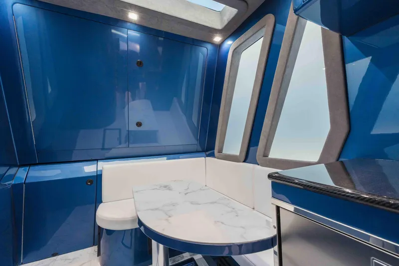 Slide: The Image of Luxurious interior of 2026 Midnight Express 52 Vitesse with sleek blue design and marble table. - 41