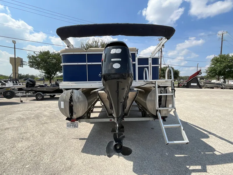 Slide: The Image of A 2016 SilverWave 210L pontoon boat with an outboard motor and a blue canopy. - 4