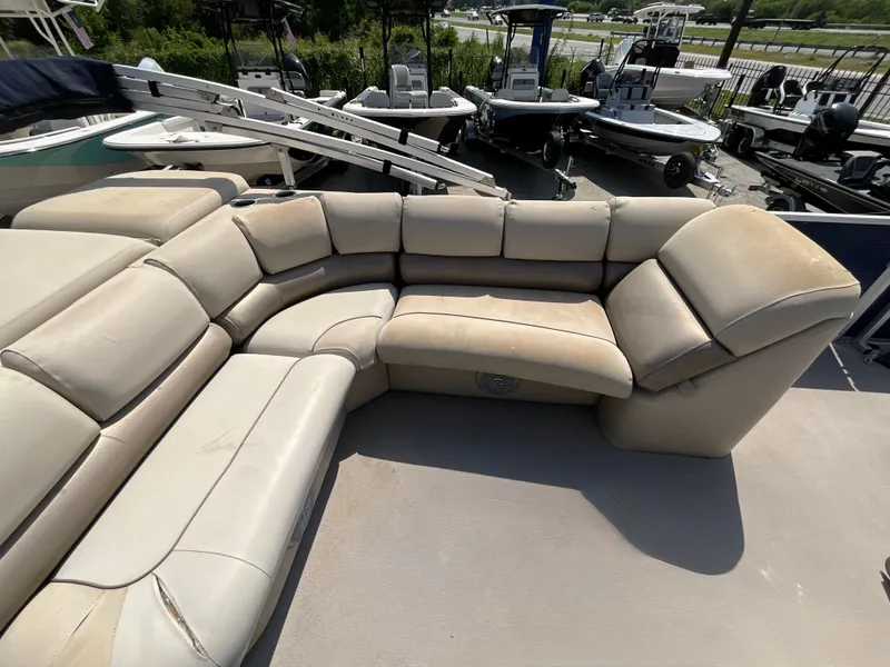 Slide: The Image of The image shows beige upholstery of a seating area on a boat, surrounded by other boats. - 8