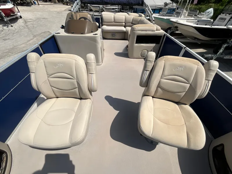Slide: The Image of The image shows the deck of a 2016 SilverWave 210L pontoon boat with beige seating. - 12