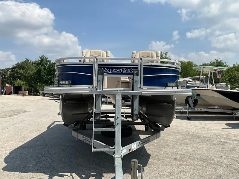 Slide: The Image of A 2016 SilverWave 210L pontoon boat on a trailer under a cloudy sky. - 3