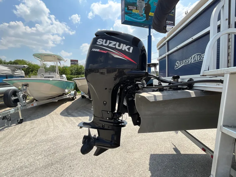 Slide: The Image of A Suzuki outboard motor is mounted on a 2016 SilverWave 210L boat, which is on a trailer. - 6