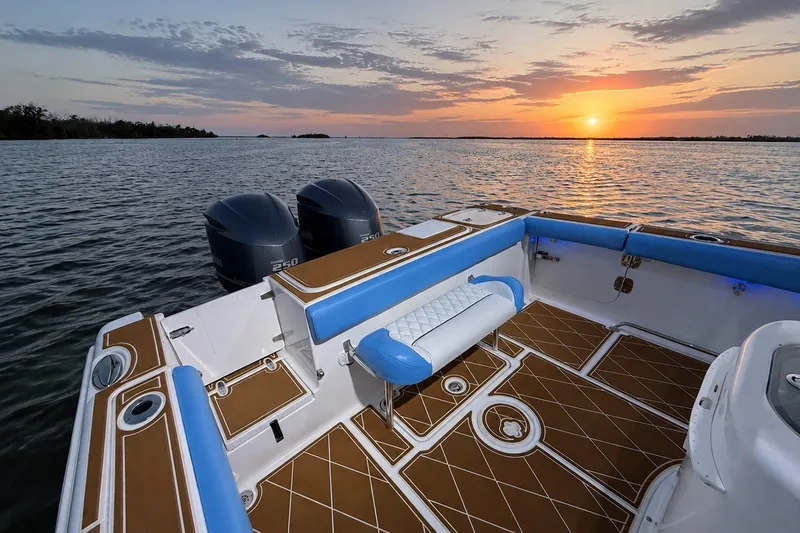 Slide: The Image of 2018 Sea Hunt Gamefish 27 boat at sunset, featuring dual engines and spacious deck. - 27