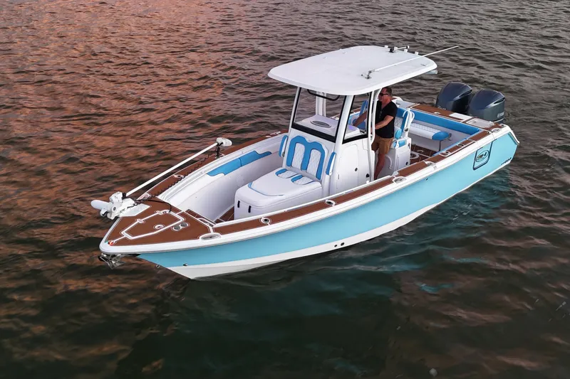 Slide: The Image of 2018 Sea Hunt Gamefish 27 Coffin Box boat on water, featuring dual engines. - 10