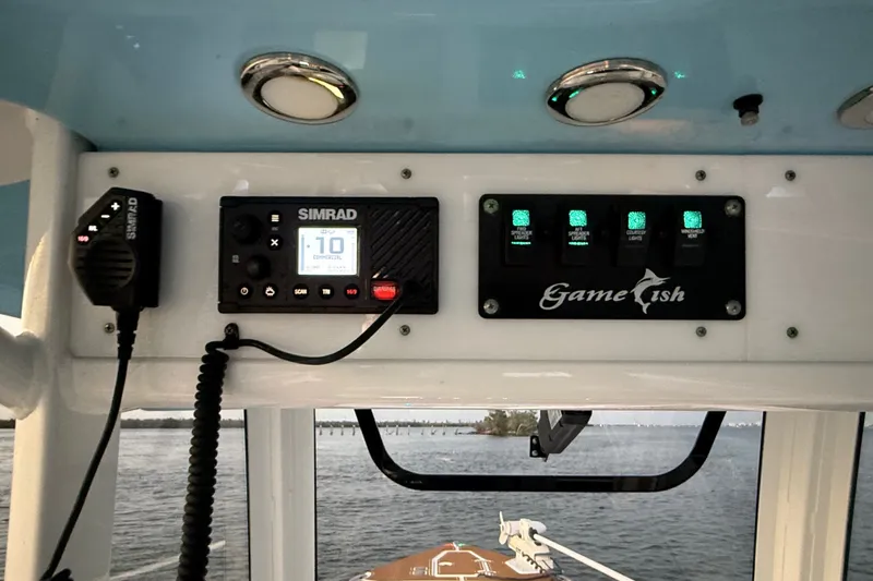 Slide: The Image of 2018 Sea Hunt Gamefish 27 Coffin Box dashboard with Simrad electronics and control panel. - 29