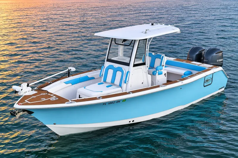 The Image of 2018 Sea Hunt Gamefish 27 Coffin Box boat on calm water at sunset. - 0