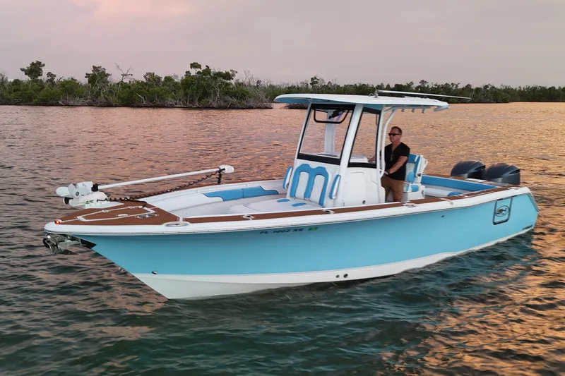 Slide: The Image of 2018 Sea Hunt Gamefish 27 Coffin Box boat on calm water at sunset. - 14