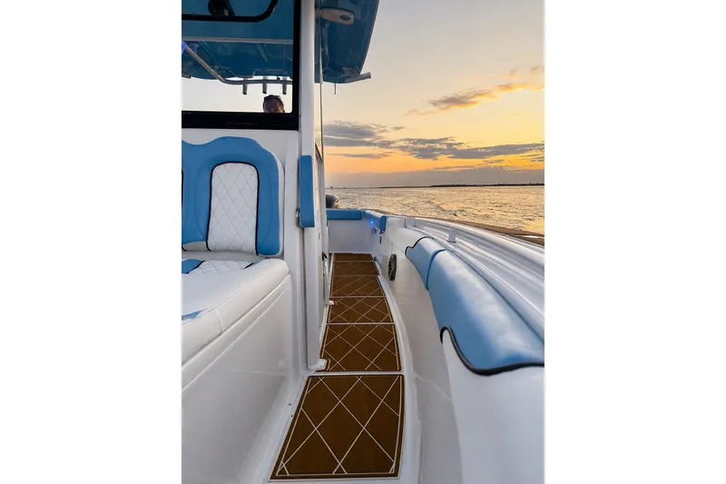 Slide: The Image of 2018 Sea Hunt Gamefish 27 Coffin Box boat interior at sunset on the water. - 30