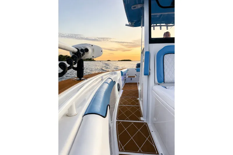 Slide: The Image of 2018 Sea Hunt Gamefish 27 boat at sunset, featuring blue and white interior. - 34