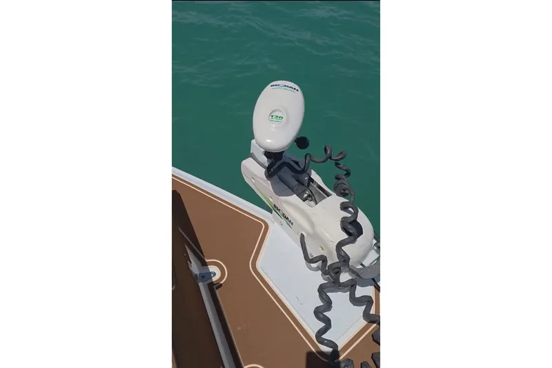 Slide: The Image of 2018 Sea Hunt Gamefish 27 Coffin Box with trolling motor on turquoise water. - 37