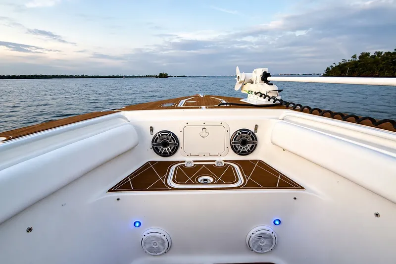 Slide: The Image of 2018 Sea Hunt Gamefish 27 Coffin Box boat on calm waters at sunset. - 24