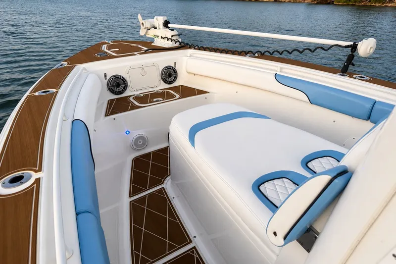 Slide: The Image of 2018 Sea Hunt Gamefish 27 Coffin Box interior with blue and white seating, on calm water. - 22
