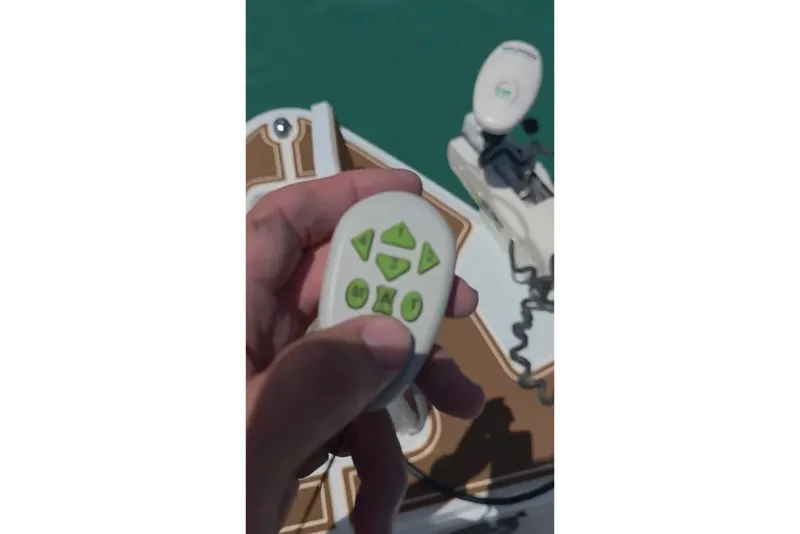Slide: The Image of Hand holding remote control on 2018 Sea Hunt Gamefish 27 Coffin Box boat. - 38