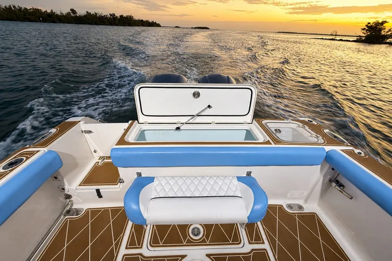 Slide: The Image of 2018 Sea Hunt Gamefish 27 Coffin Box boat cruising at sunset on open water. - 42