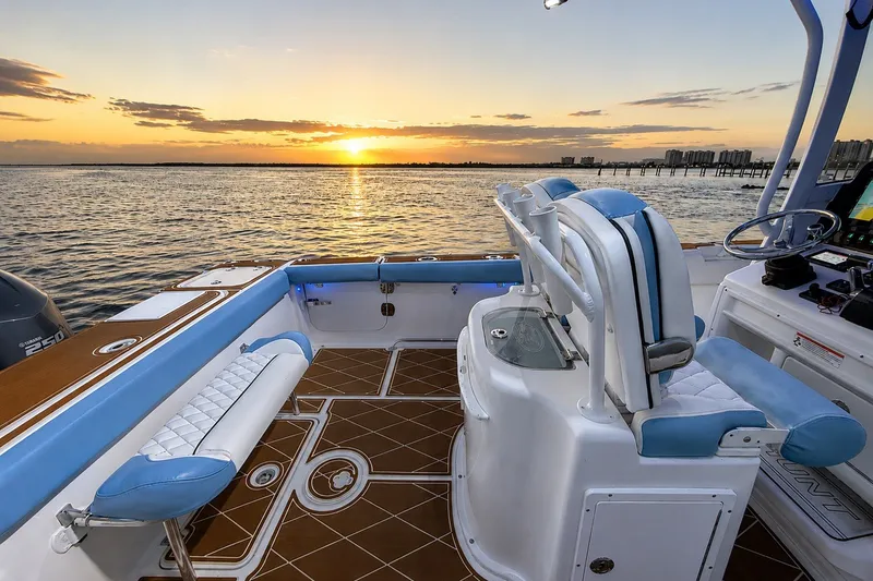 Slide: The Image of 2018 Sea Hunt Gamefish 27 boat interior at sunset, featuring elegant seating and ocean view. - 26