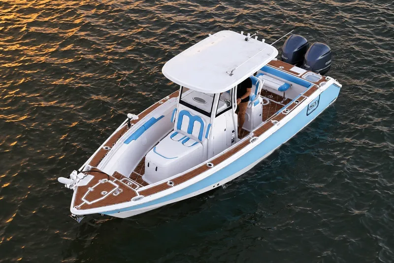 Slide: The Image of 2018 Sea Hunt Gamefish 27 Coffin Box boat on water at sunset. - 19
