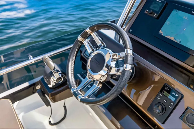 Slide: The Image of Steering wheel and controls of 2021 Galeon 500 Fly yacht, with navigation display. - 34